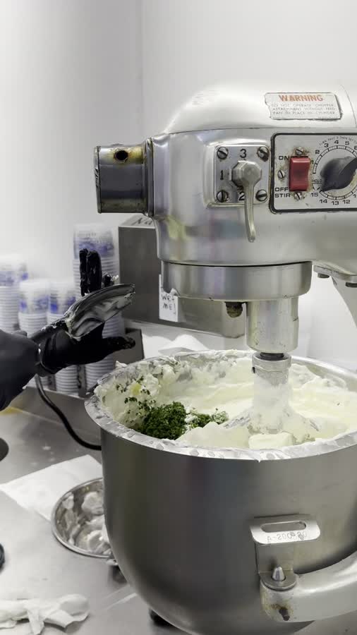 Folding fresh ingredients into the crab dip